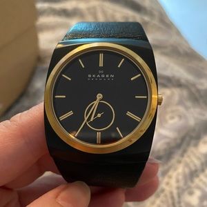 Skagen black leather and gold women’s watch.
